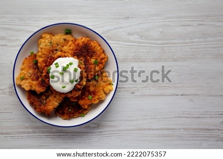 Homemade Fried Cheddar Corn Fritters on a Plate, top view. Flat lay, overhead, from above. Copy space. Royalty-Free Stock Photo #2222075357