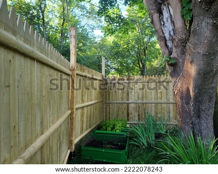 The corner of a newly constructed wooden fence. Royalty-Free Stock Photo #2222078243
