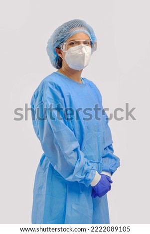 studio portrait of 40s hispanic female surgery doctor or researcher with full protective cloth of PPE gown face mask cap and surgery glove isolated on white background Royalty-Free Stock Photo #2222089105
