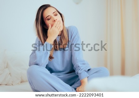 
Tired Woman Yawning Feeling Sleepy Relaxing at Home. Exhausted person trying to rest and relax on the weekend 
 Royalty-Free Stock Photo #2222093401