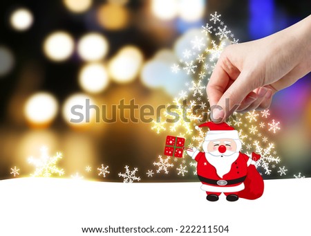 Young woman hand holding santa claus