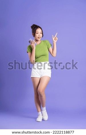 full body image of beautiful asian girl posing on pink background