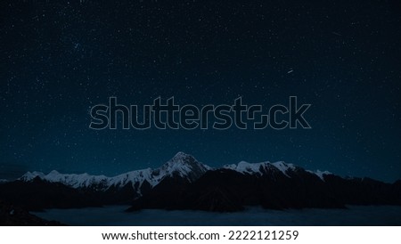 Starry night sky and snow mountain