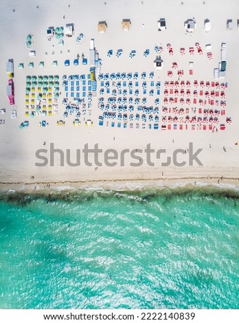 Drone aerial view at Miami South Beach Florida, Beach with colorful chairs and umbrellas