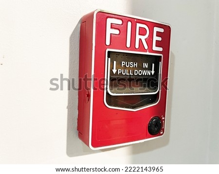 Fire alarm switch on the hotel wall. Closeup photo, blurred.