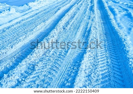 Texture of a snowy road with traces of car tires. Winter driving concept.