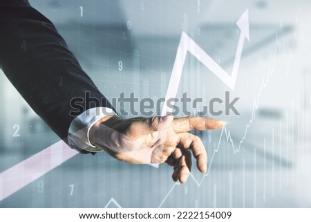 Double exposure of man hand presses on abstract creative financial chart and upward arrow on blurred office background, research and strategy concept