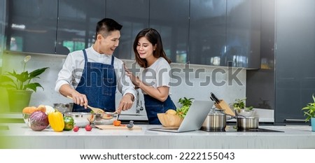 Portrait of smile asian couple cooking food with pot and pan in the kitchen. Happy asian family with father mother, family’s day, together healthcare cooking plant based diet food concept