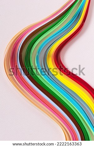 Abstract pattern of quilling stripes. Multicolored wave on pink paper background