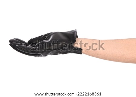 Man wearing black leather glove on white background, closeup. Side view. High resolution photo. Full depth of field.