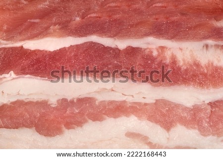 Fresh pork sliced small portions. Raw bacon background. High resolution photo. Full depth of field.