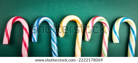 Abstract colorful holiday background. Candy canes,  horizontal banner.