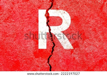 Letter R background with red color painted on broken wall with cracks