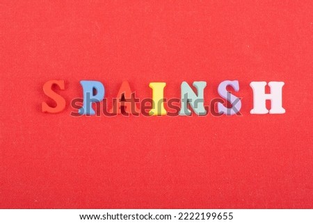 SPAIN word on red background composed from colorful abc alphabet block wooden letters, copy space for ad text. Learning english concept