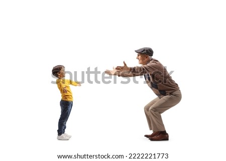 Full length profile shot of a boy spreading arms to hug grandfather isolated on white background Royalty-Free Stock Photo #2222221773