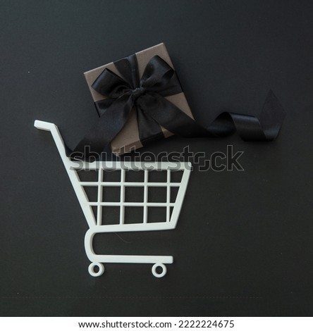 Gift box in a Shopping Cart. Black Friday Sale, Christmas presents. E commerce, online shop sales concept