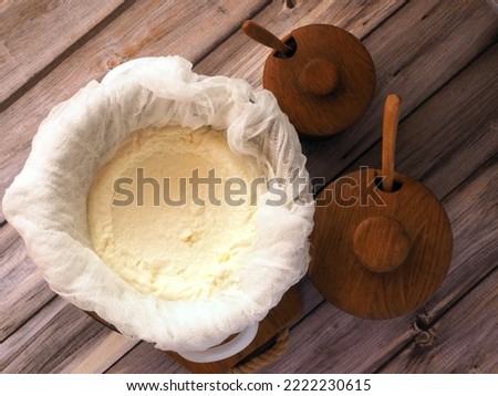 Preparation of homemade cottage cheese. The process of draining filtration of curdled milk and separation of whey by cheesecloth. Flat lay. Royalty-Free Stock Photo #2222230615