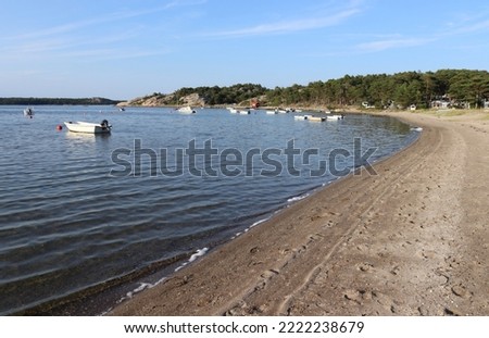 Summer evenings view of the beach and bay at Kyrkviken, on the beautiful island of Reso, on Sweden's idyllic West Coast. Bohulsan archipelago near Kosterhavet National Marine Park. Royalty-Free Stock Photo #2222238679