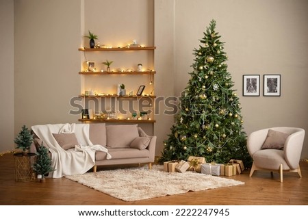 Modern Christmas living room interior in studio apartment. Large decorated Christmas tree, sofa, plaid, gift boxes, fluffy carpet, light garlands. 
