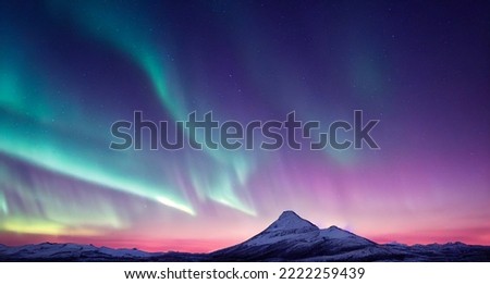 Northern Lights over snowy mountains. Aurora borealis with starry in the night sky. Fantastic Winter Epic Magical Landscape of snowy Mountains.   Royalty-Free Stock Photo #2222259439