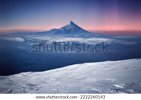 Northern Lights over snowy mountains. Aurora borealis with starry in the night sky. Fantastic Winter Epic Magical Landscape of snowy Mountains.   Royalty-Free Stock Photo #2222260143