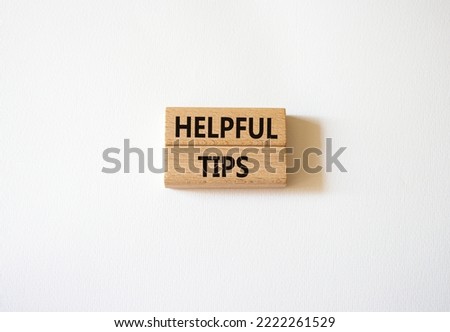 Helpful tips symbol. Wooden blocks with words Helpful tips. Beautiful white background. Business and Helpful tips concept. Copy space.