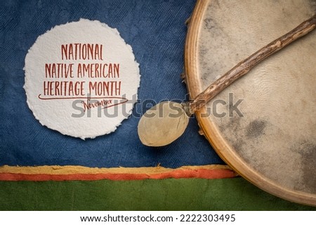 November - National Native American Heritage Month, handwritten note with a shaman drum and beater against abstract paper landscape, reminder of historical and cultural event Royalty-Free Stock Photo #2222303495
