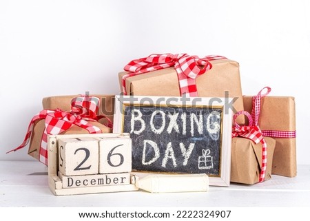 Boxing day sale seasonal promotion background. Various presents gift box with ribbon, with inscription frame Boxing day, block wooden calendar, wrapping holiday paper, Christmas decor, ribbons Royalty-Free Stock Photo #2222324907
