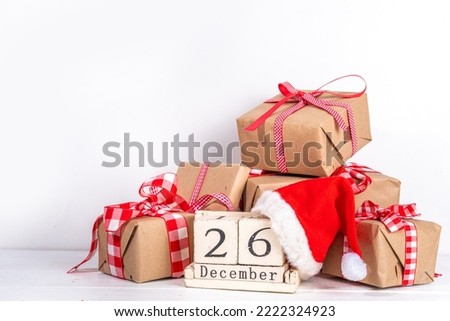 Boxing day sale seasonal promotion background. Various presents gift box with ribbon, with inscription frame Boxing day, block wooden calendar, wrapping holiday paper, Christmas decor, ribbons Royalty-Free Stock Photo #2222324923