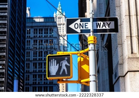 White "Walk sign" pedestrian traffic light  and one way sign in New York City, NY, USA Royalty-Free Stock Photo #2222328337