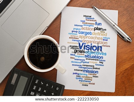 "VISION word cloud arrangement" Notebook with text vision on table with coffee, calculator and notebook