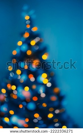 Festive Xmas Background. Bright Glowing Blur Christmas Tree Bokeh Lights. Traditional Decor for Winter Holidays. Abstract Cozy Winter.