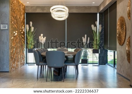 Roller blinds in the interior. Automatic blackout shades large size on the windows. Modern interior with wood decor panels on the wall. Green plants in hi-tech flower pots. Electric curtains for home. Royalty-Free Stock Photo #2222336637