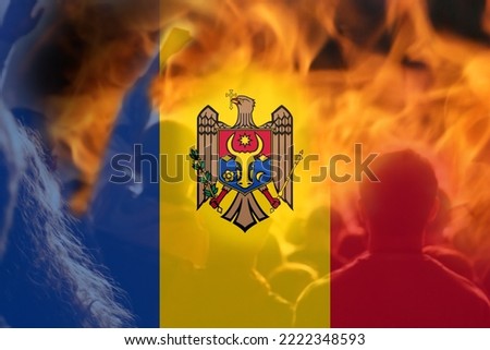 Defocus protest in Moldova. Moldova flag painted on fire flame background. Strength, Power, Protest and punch concept. Russia war. World crisis news. Military coup. Out of focus.