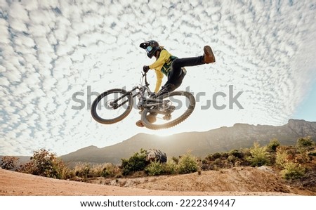 Dessert, mountain bike and high jump trick for crazy fun competitive race, extreme sports performance and stunt freedom. Dirt biker flying in the air, adrenaline sport risk and awesome adventure ride Royalty-Free Stock Photo #2222349447