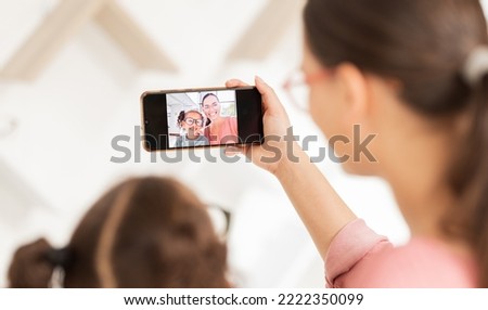 Family phone selfie, mother and girl at optometry hospital taking picture for happy memory together. Love, care and 5g mobile photo of mom bonding with kid for social media, online or internet post.