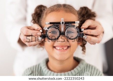 Eye, vision and test with child for glasses in optometry office for eye care and health. Eyewear, exam and medical opthalmology with little girl testing for lenses and frames diagnosis for optics Royalty-Free Stock Photo #2222350243