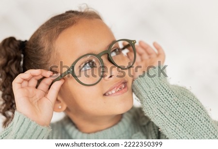 Child, glasses and eye care for vision, focus and concentration while wearing quality lens frame optician choice. Face of girl looking happy about optics fashion mockup for eyesight correction Royalty-Free Stock Photo #2222350399