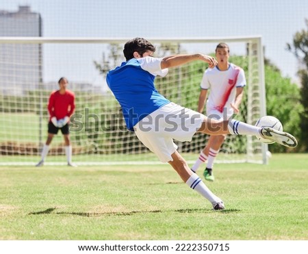 Sports, soccer and athlete scoring a goal during a match or training on an outdoor pitch at a stadium. Football, fitness and healthy man practicing to score at a game for exercise or workout on field Royalty-Free Stock Photo #2222350715