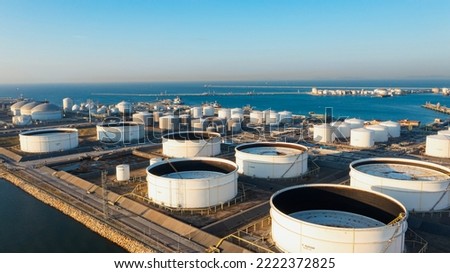 Aerial top view of White oil tank storage chemical petroleum petrochemical refinery product at oil terminal. Oil terminal storage tank in deep seaport for the international order concept.  Royalty-Free Stock Photo #2222372825