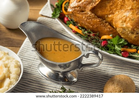 Homemade Thanksgiving Turkey Gravy in a Boat Royalty-Free Stock Photo #2222389417