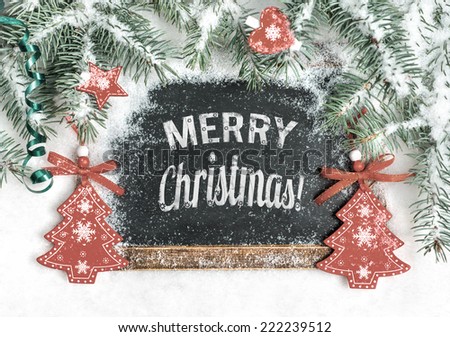 Black chalkboard on snow with caption "Merry Christmas!", toned image