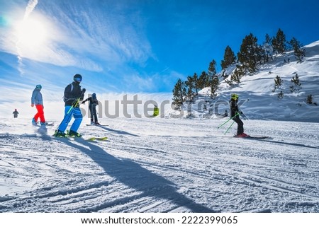 Group of people skiing and snowboarding down the ski slope or piste in Pyrenees Mountains. Winter ski holidays in El Tarter, Grandvalira, Andorra Royalty-Free Stock Photo #2222399065