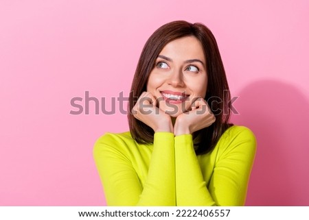 Photo of dreamy sweet lady wear yellow top looking empty space arms cheeks chin isolated pink color background