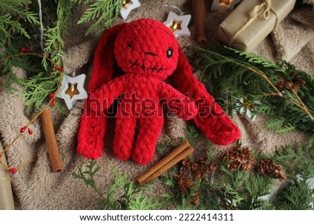 TOY IN NEW YEAR'S DECORATIONS. Kids toys. Gifts for the New Year. New Year's decor, halloween, darkness, fear. Knitted toy. Hobby