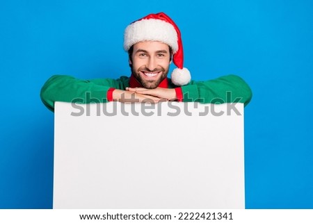 Photo of cheerful stylish man hold banner billboard poster present demonstrate empty blank space isolated on blue color background