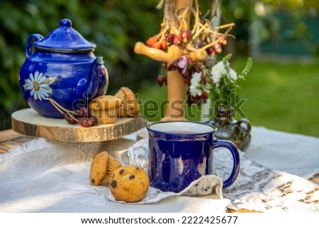 Tea in an enameled blue mug, autumn tea party, natural tea from dry rosehip fruits