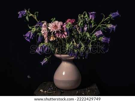 Wilting flower bouquet inside of a vase Royalty-Free Stock Photo #2222429749