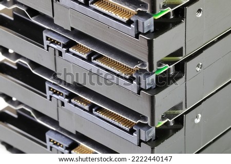 pile or stack of HDD, SSHD Hybrid hard disk drives 3.5" standard profile show on SATA interface, isolated on white background