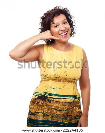 portrait of a mature woman doing the telephone gesture on a white background